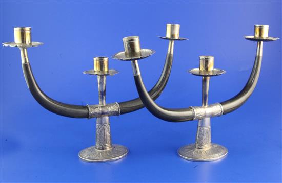 A pair of mid 20th century Eastern silver and horn two branch, three light candelabra, weighted.